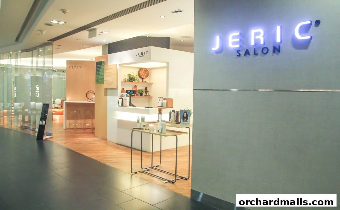 The exterior of Jeric Salon, featuring a prominent neon sign and display of beauty products.