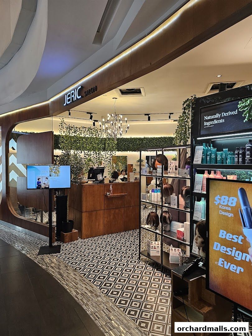 The entrance of JERIC SALON, featuring a reception desk, product displays, and decorative plants.