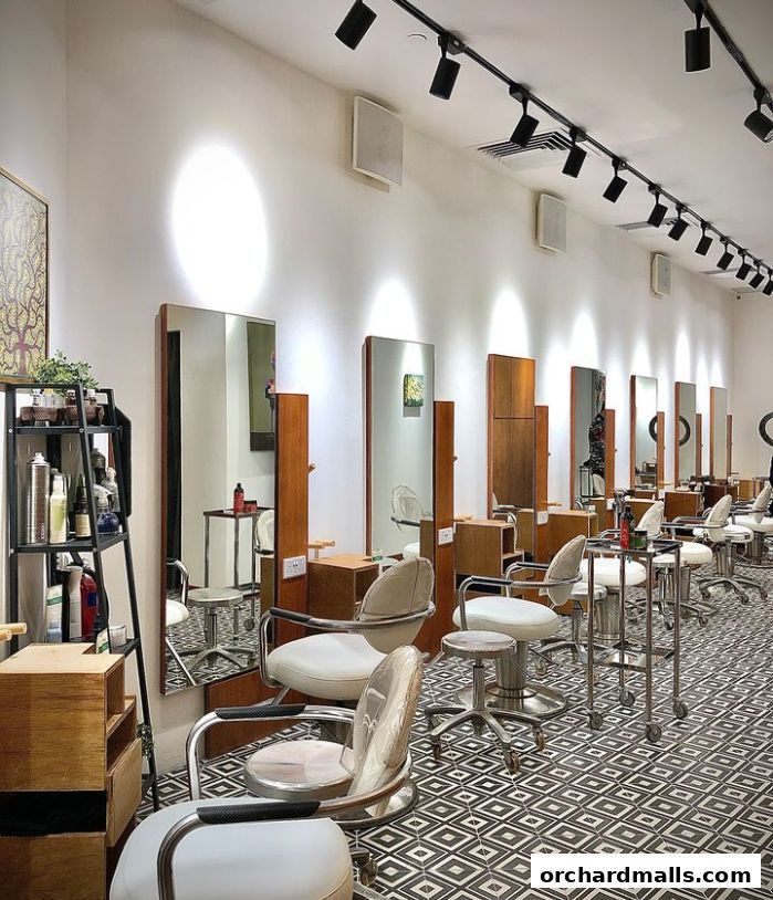 Interior of a modern hair salon with styling chairs, mirrors, and product shelves.