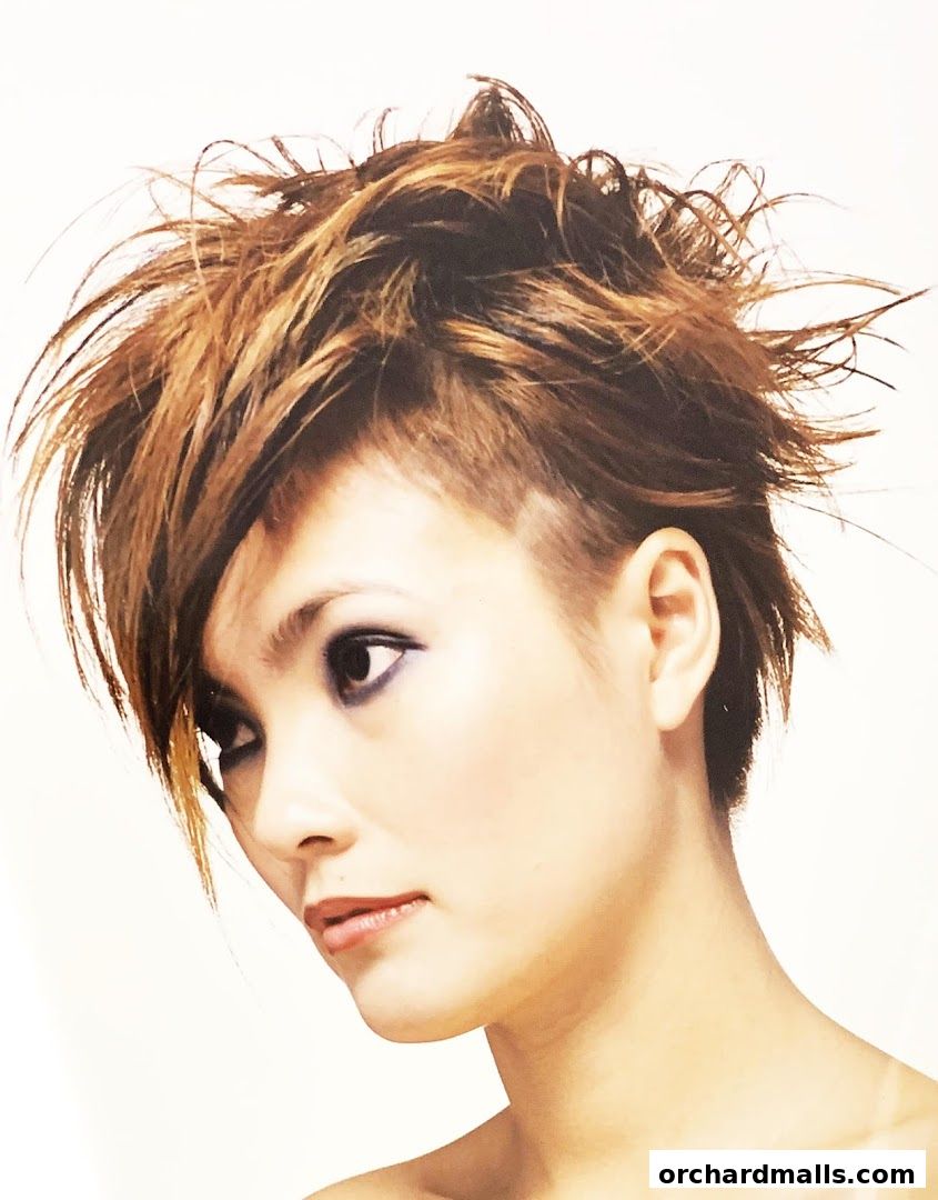A woman with a stylish, spiky, layered haircut and dramatic eye makeup.