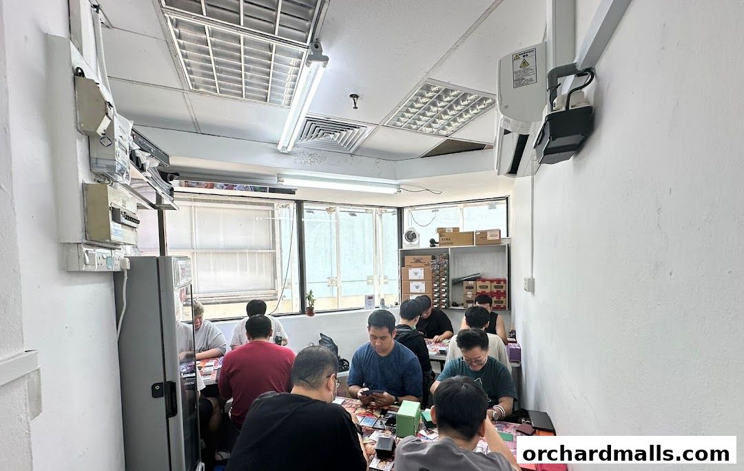 People playing card games at tables inside a retail shop.
