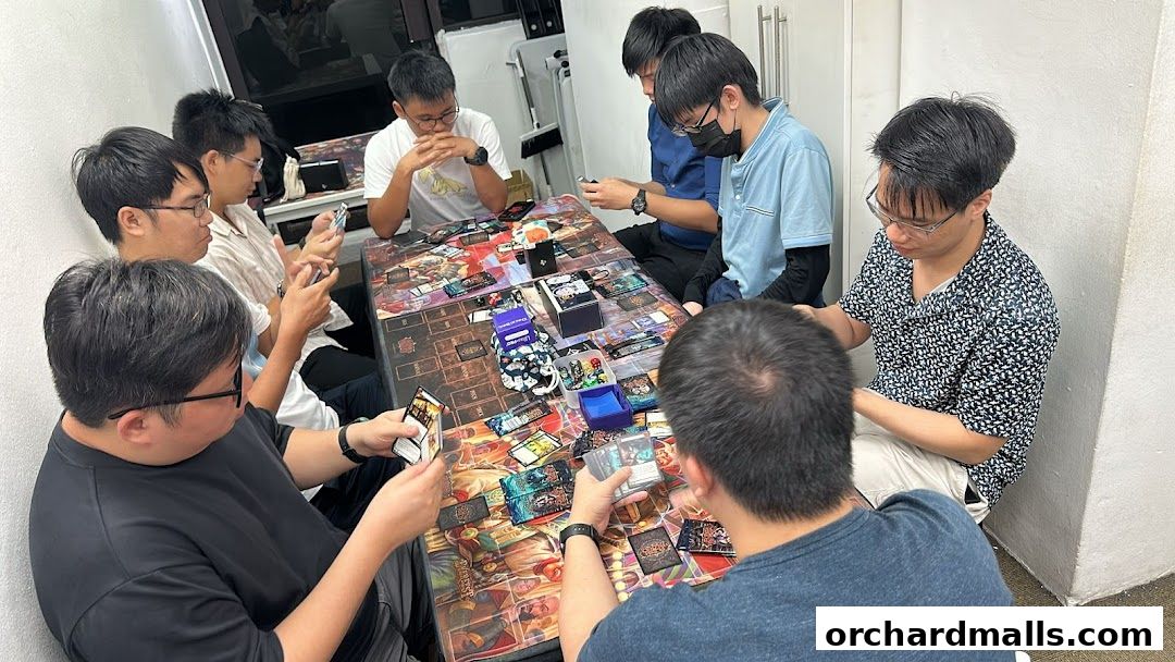 A group of people playing a card game around a table.