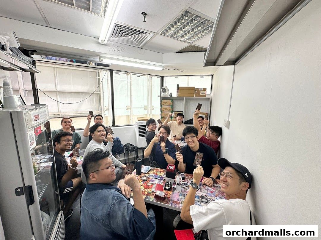 A group of people are gathered around a table, playing a card game at Jeux Kingdom.