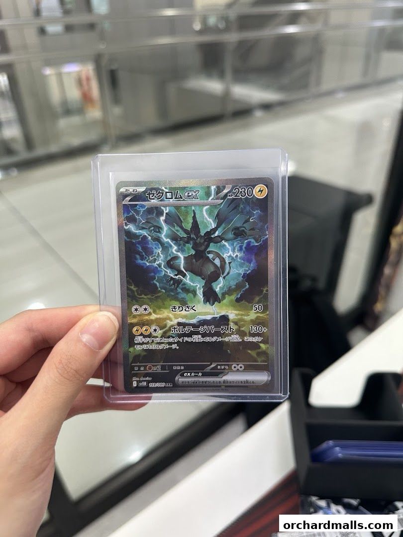 A hand holds a collectible trading card featuring a dragon-like creature with lightning.