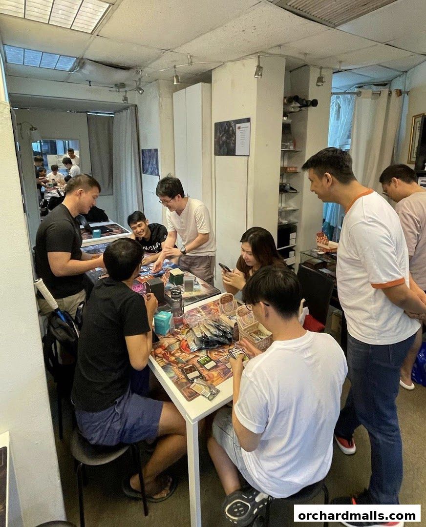 People playing card games at tables inside a retail store.