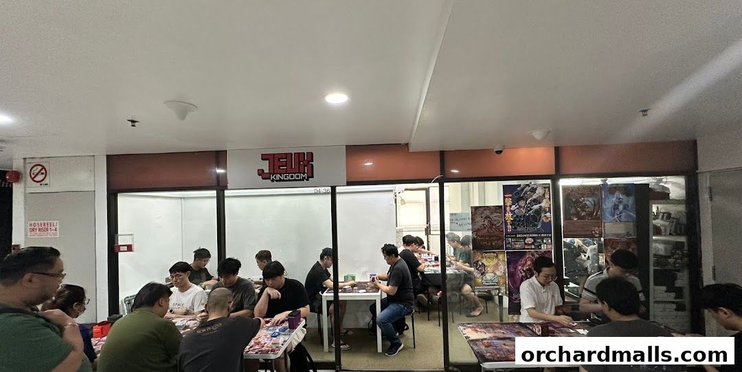 People playing card games inside Jeux Kingdom, a retail shop.