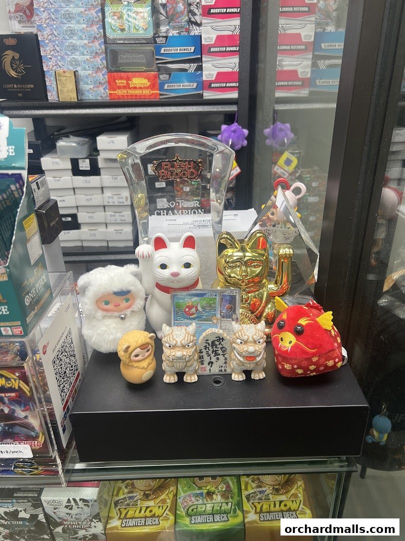 A display of collectible trading cards, figurines, and trophies in a retail shop.