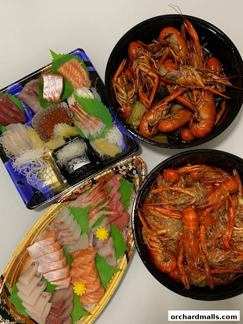 A spread of fresh sashimi and cooked crawfish, ready to be enjoyed.