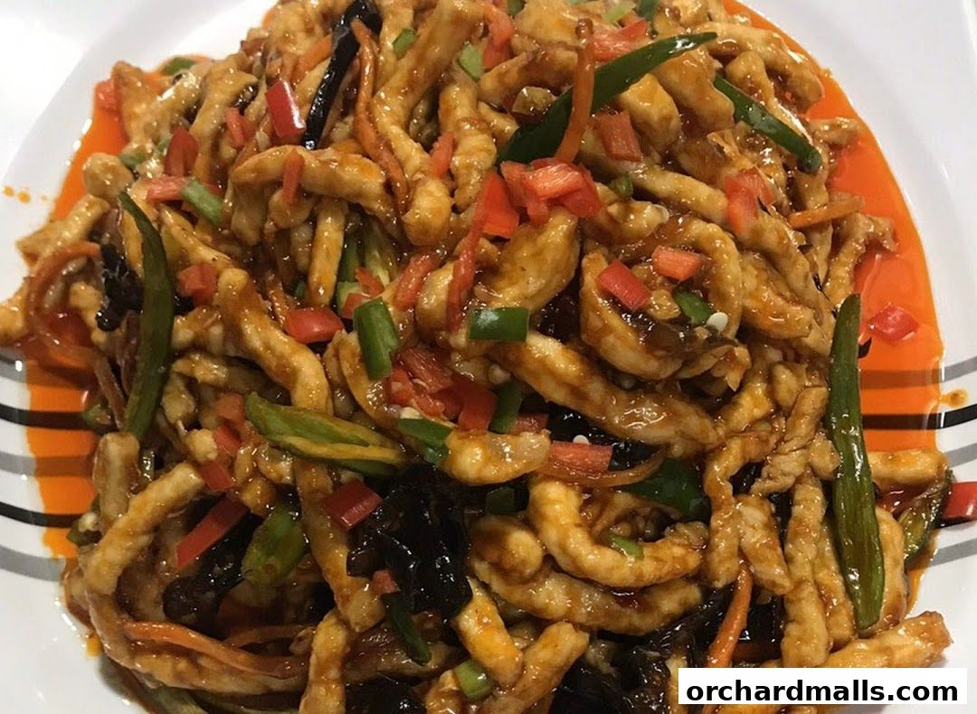 A close-up shot of a delicious stir-fried dish with shredded meat and vegetables.