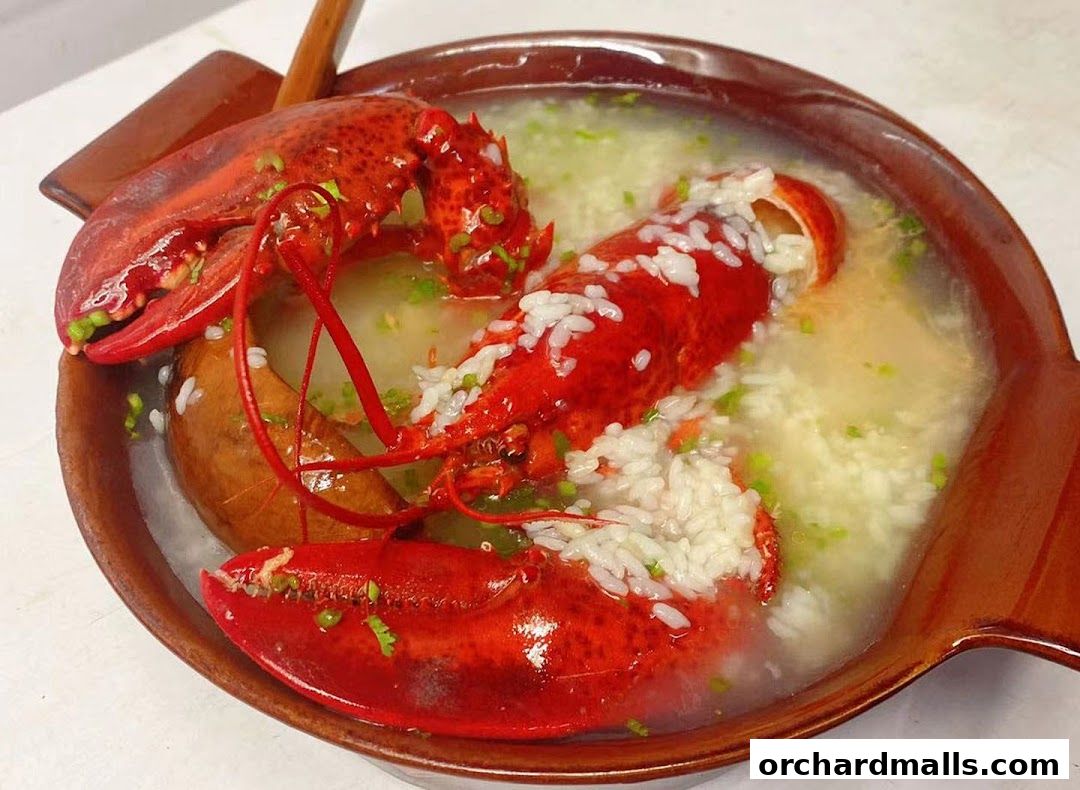 A close-up of a delicious lobster congee served in a rustic brown bowl.