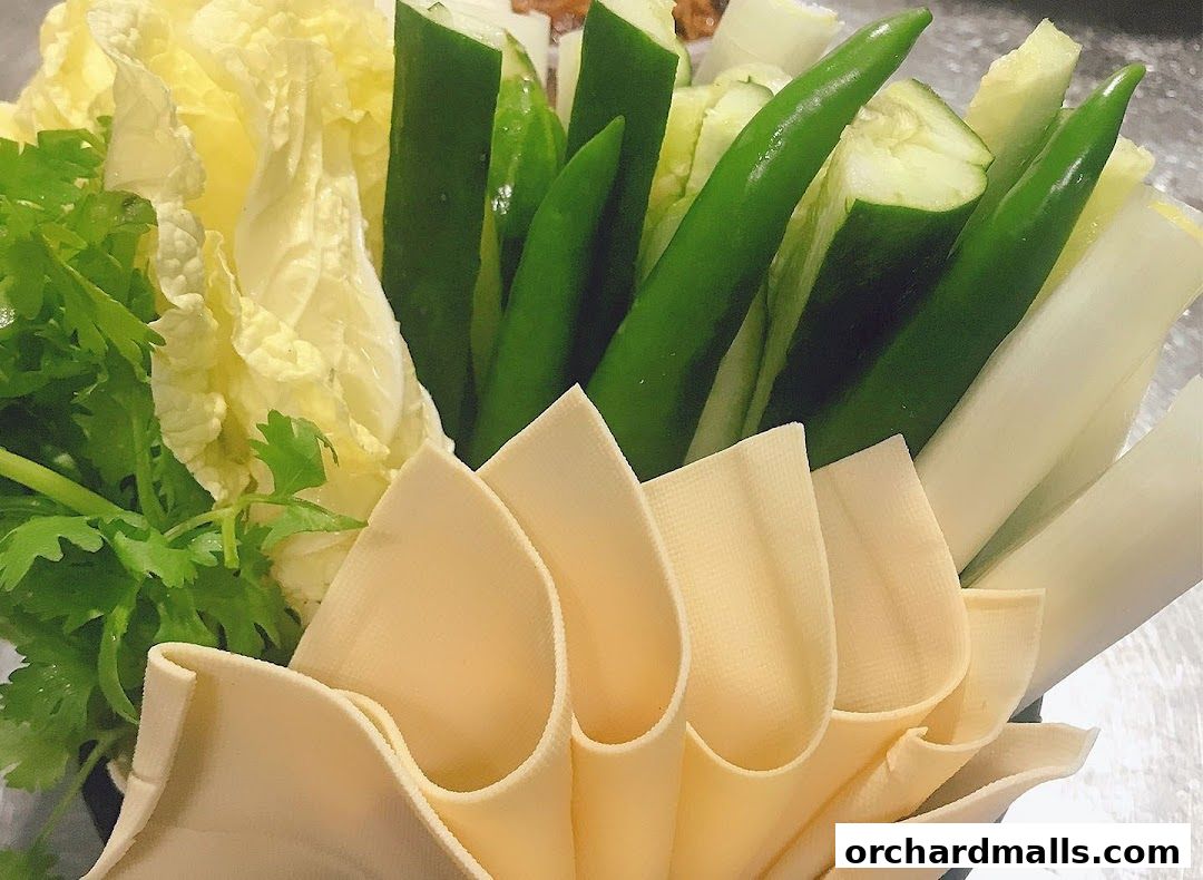 A close-up of fresh vegetables and tofu skin arranged for a meal.