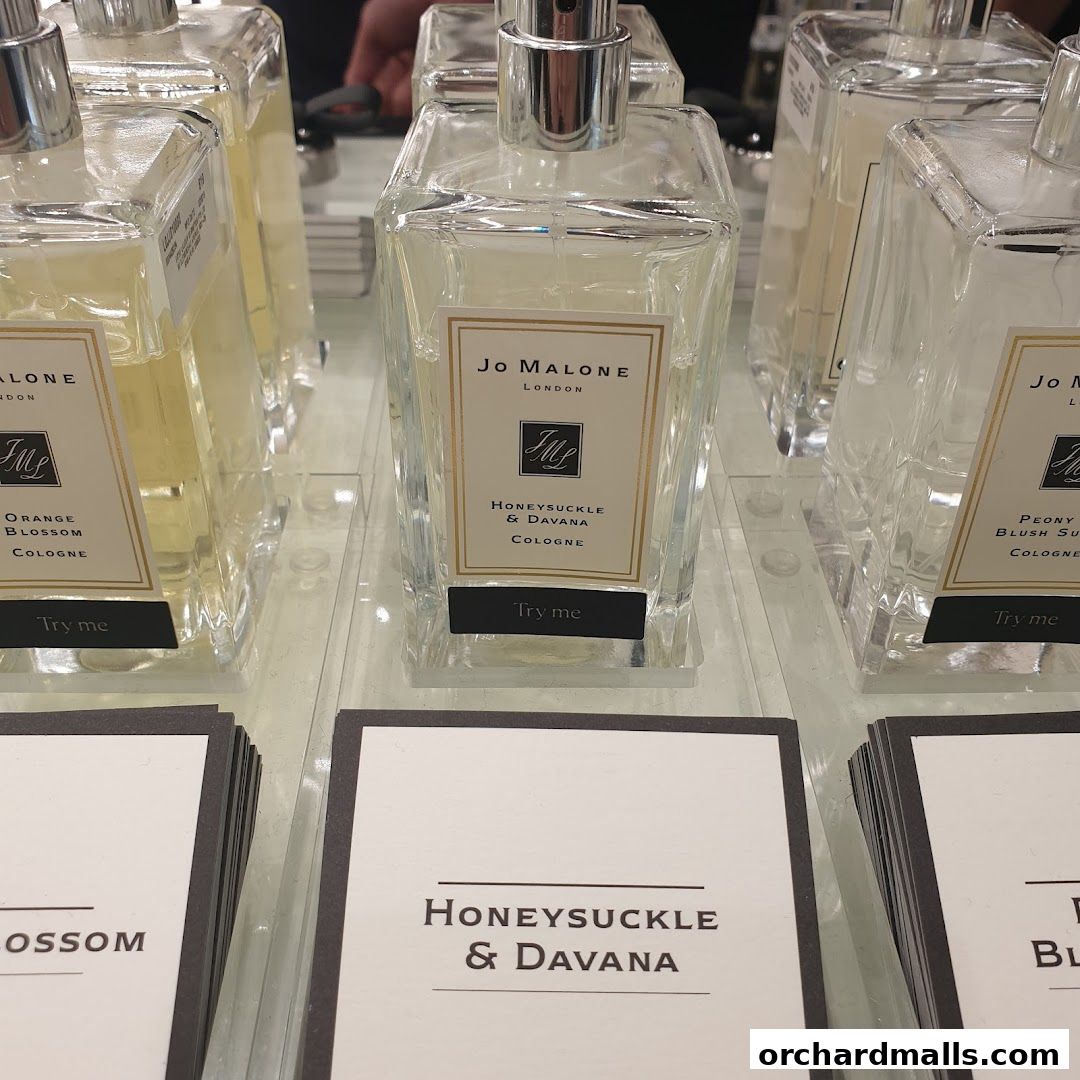 Jo Malone London perfumes displayed with 'Try me' tags and product name cards.