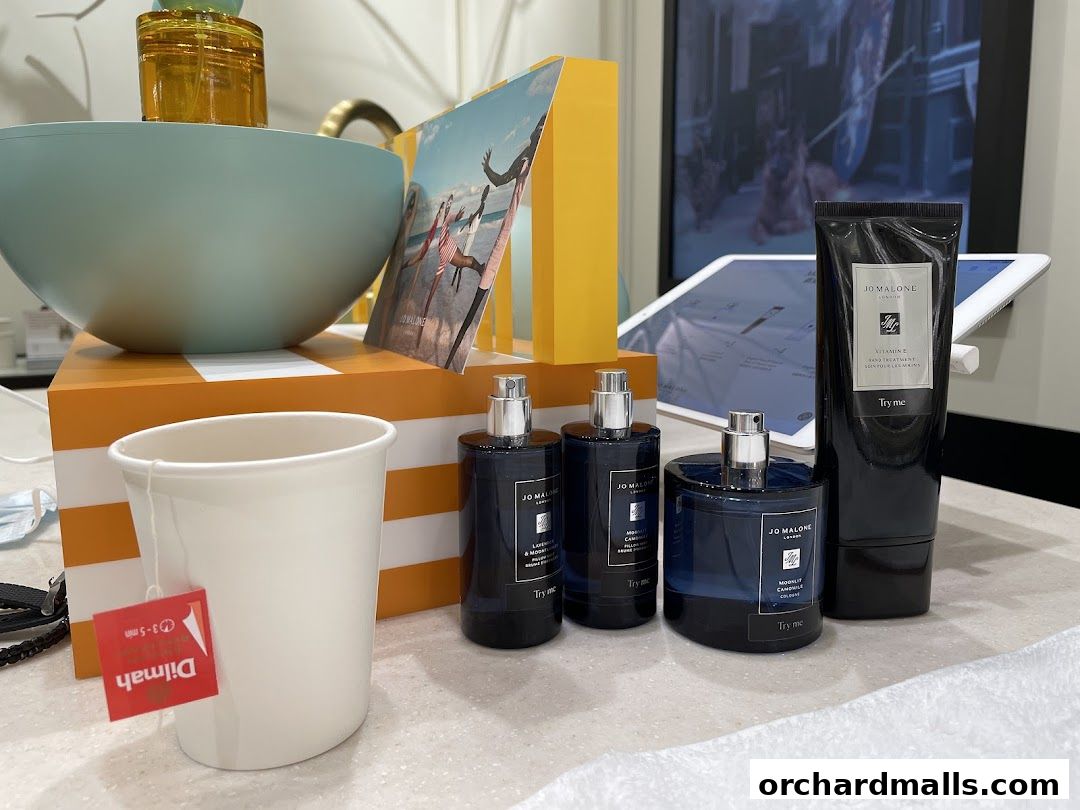 Jo Malone London products displayed with a cup of tea and promotional materials.