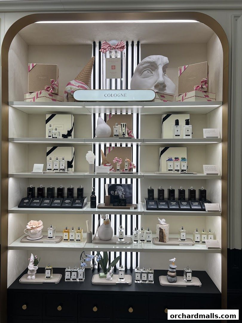 Jo Malone London display featuring colognes, gift boxes, and decorative items.