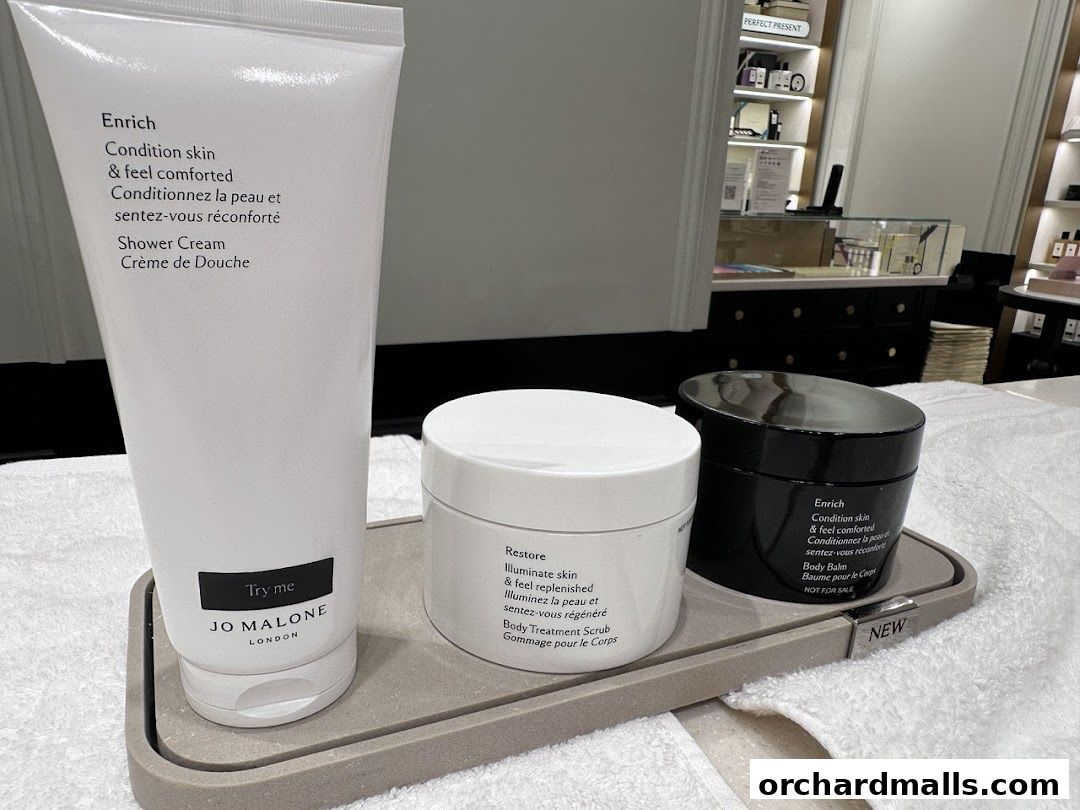 Jo Malone London products including shower cream, body scrub, and body balm on display.