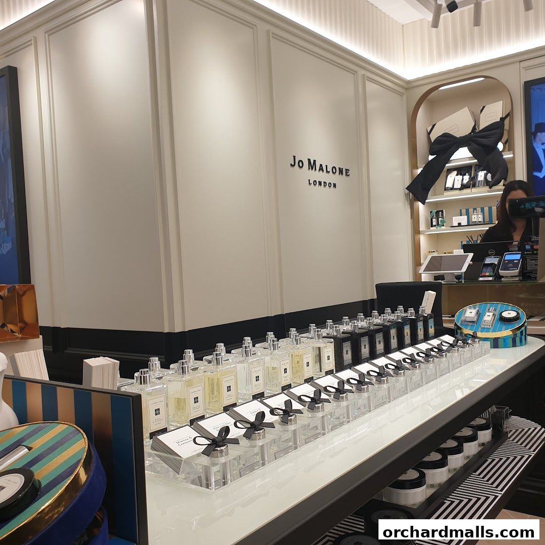 Jo Malone London shop interior with rows of perfume bottles and branded packaging.