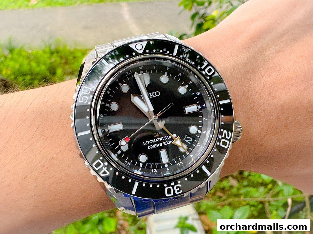 A close-up shot of a Seiko GMT automatic dive watch on a person's wrist.