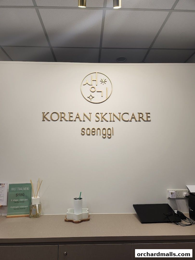 The K-Beauty Saenggi shop features a clean white wall with its logo and name.