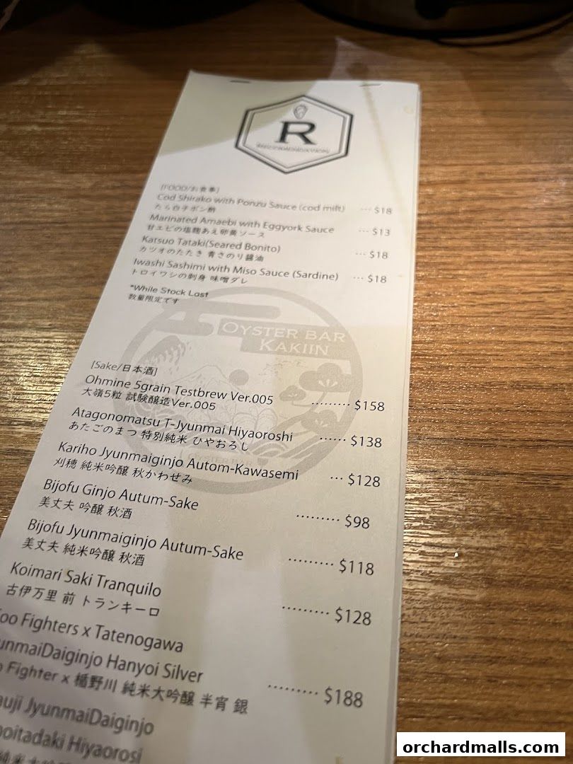 A menu from Kakiin Oyster Bar featuring various seafood and sake options.