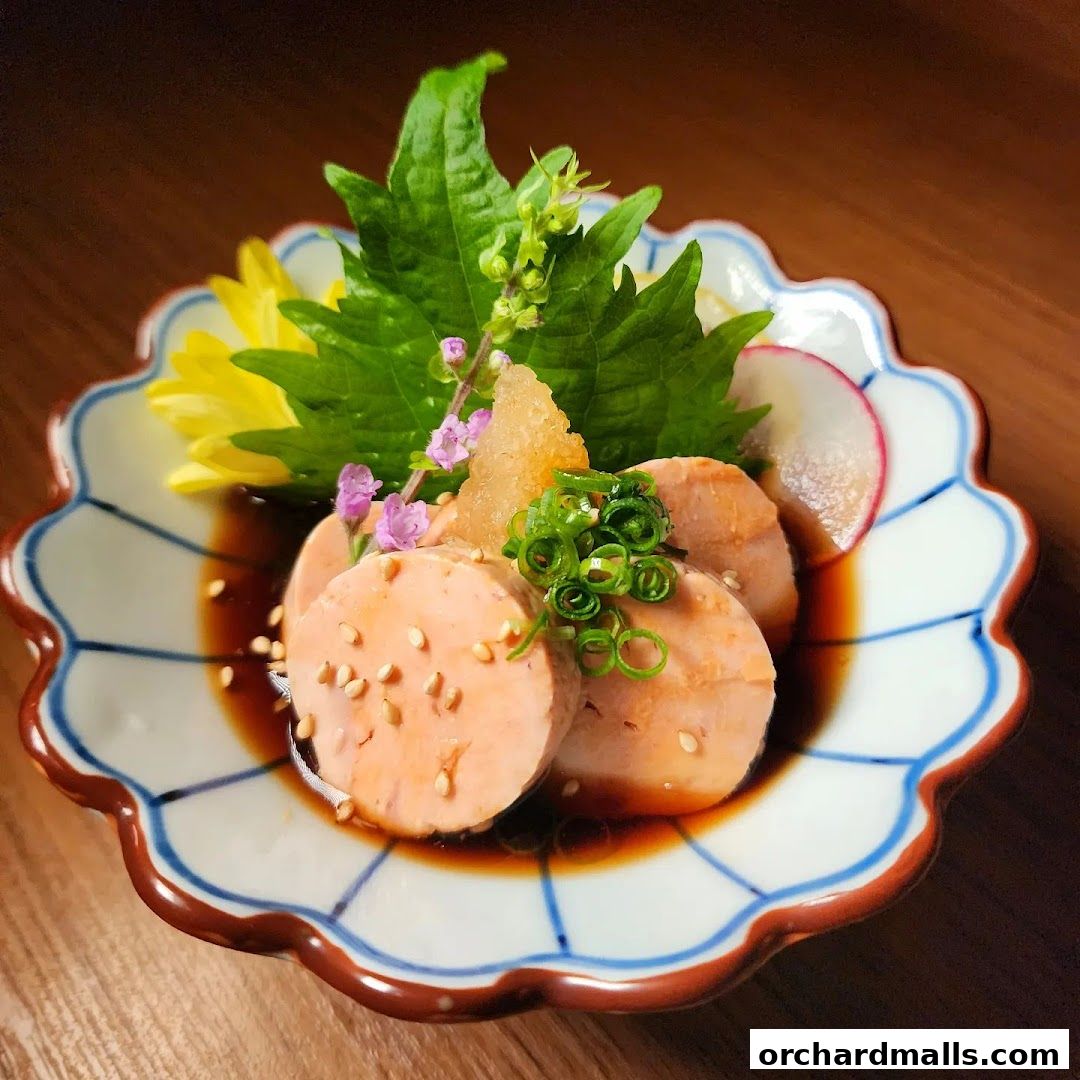 A beautifully presented dish of sliced seafood with garnishes on a decorative plate.