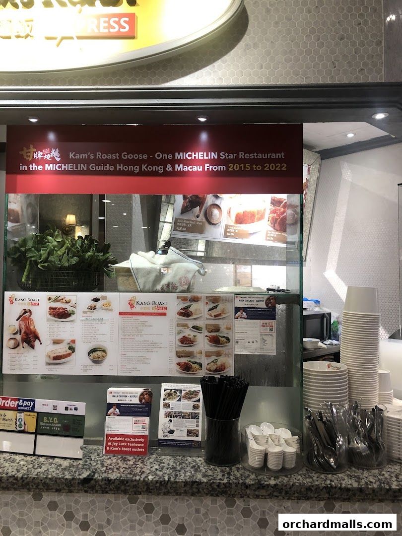 Kams Roast Express ION shop front with menus and roast goose displayed.
