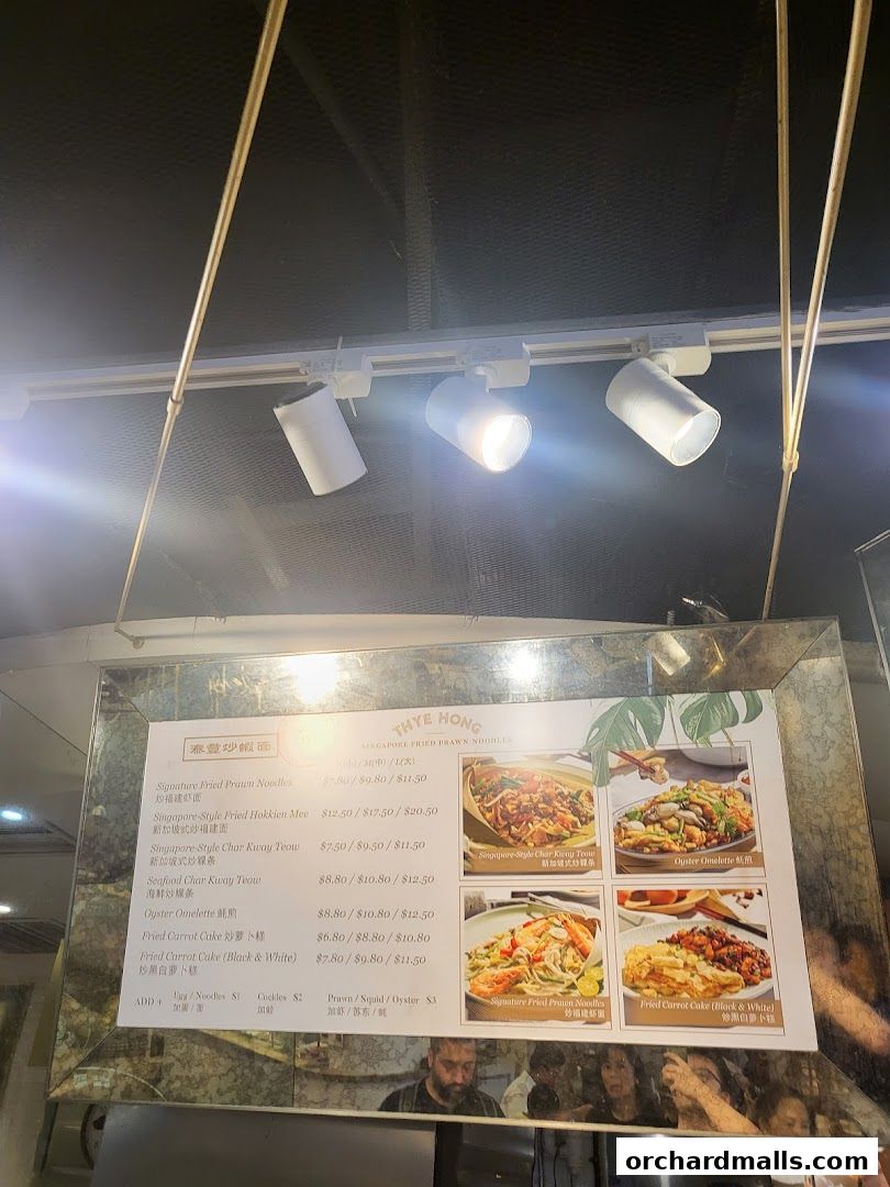A menu board for Thye Hong Singapore Fried Prawn Noodles with various dishes and prices.