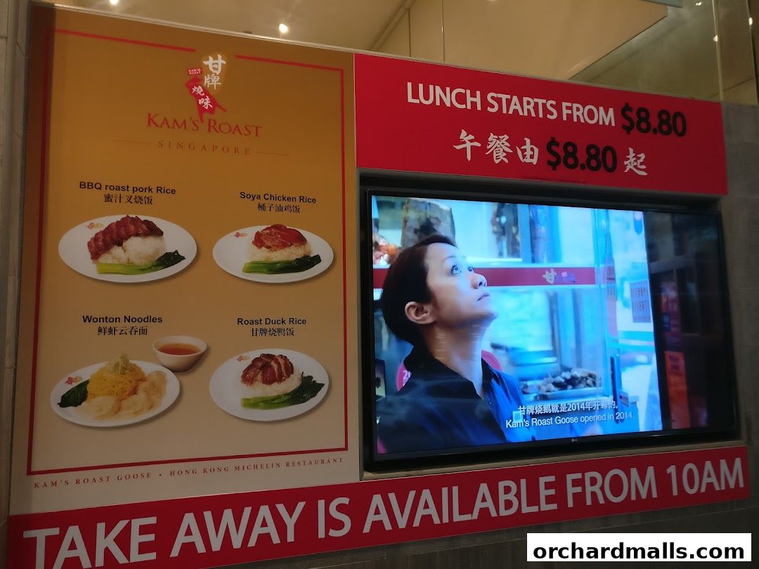 A display board showcasing Kam's Roast Singapore's signature dishes and lunch promotions.
