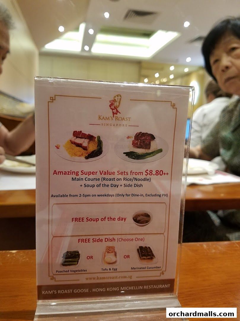A menu display for Kam's Roast Express featuring value sets with main courses, soup, and side dishes.