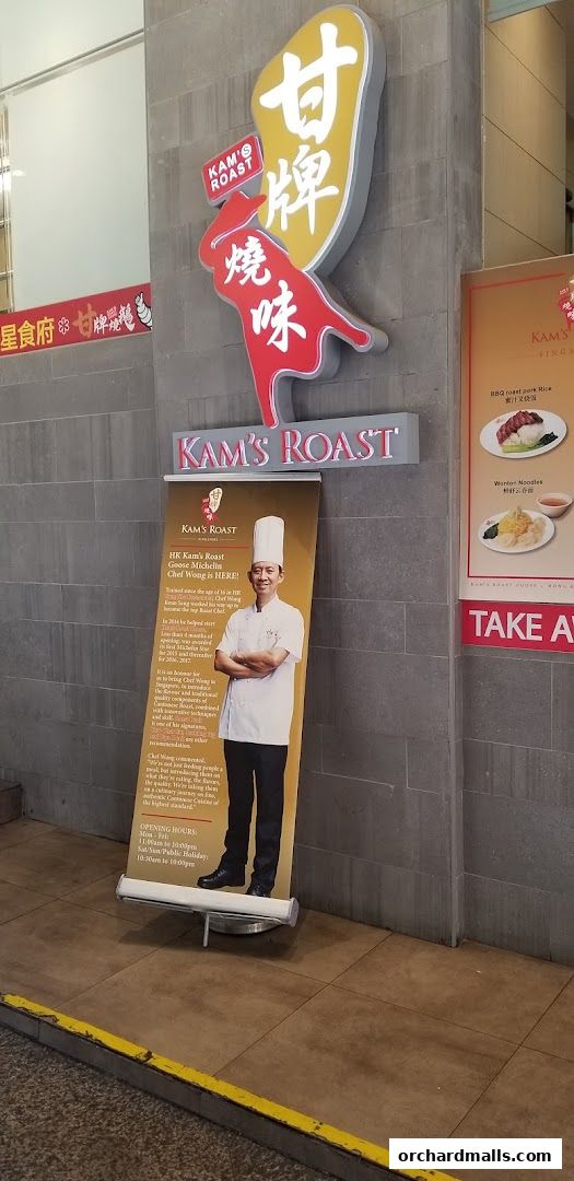 Kam's Roast Express ION shop front with a banner featuring Chef Wong and menu highlights.