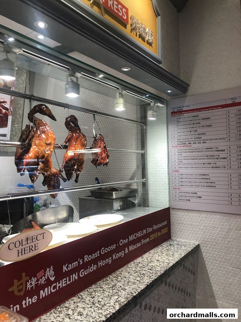 A menu board displaying various roast meats and noodle dishes with prices at Kam's Roast Express.