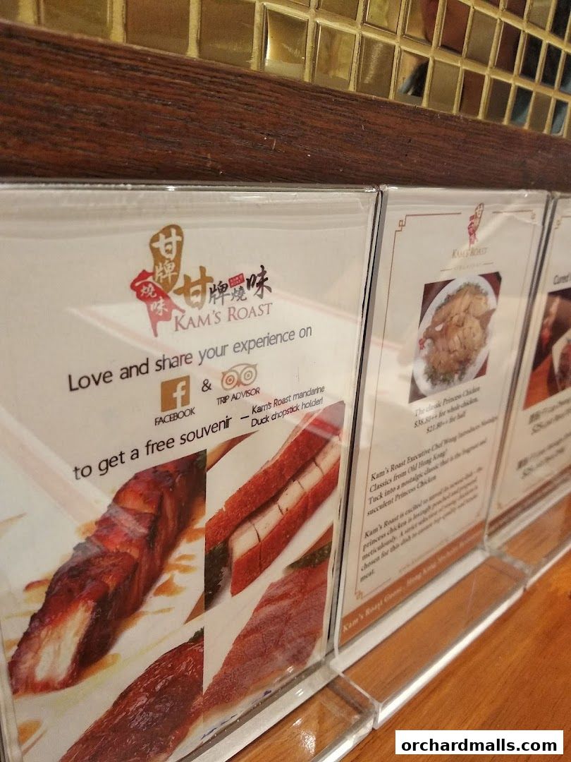 A display of menus featuring roasted meats and chicken from Kam's Roast.