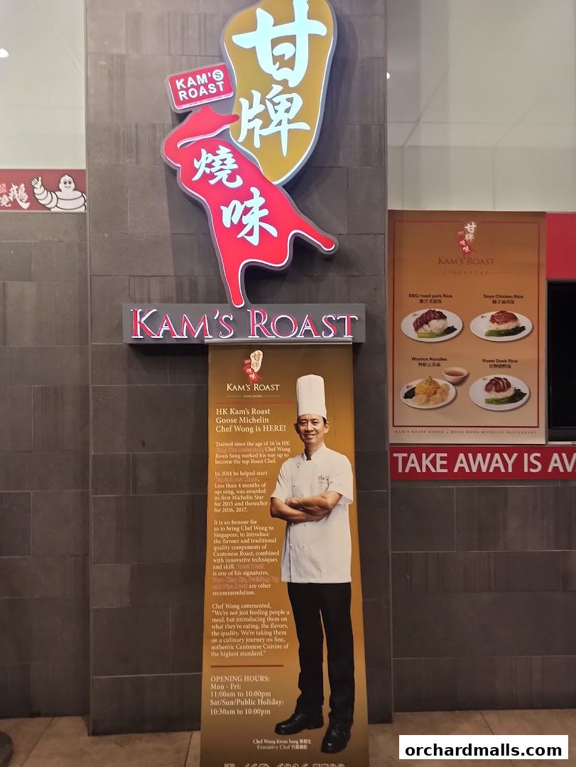 Exterior signage and promotional banner for Kam's Roast Express, featuring the restaurant's logo and a chef.