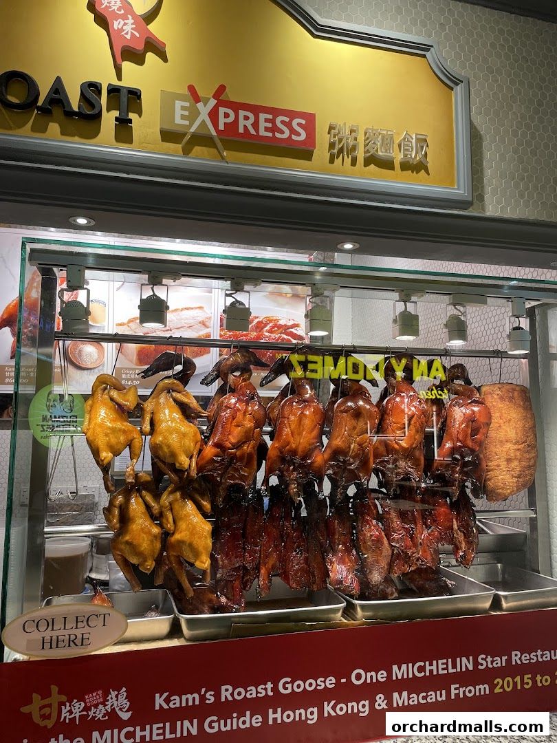 A display of various roasted meats, including ducks and chickens, at Kams Roast Express.