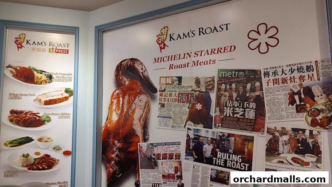 A wall display at Kam's Roast Express featuring roast meats and newspaper clippings.