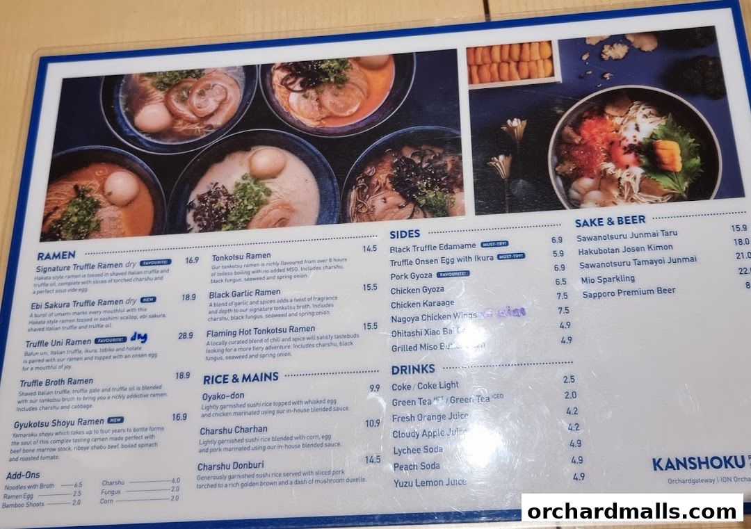 A menu from Kanshoku Ramen Bar featuring various ramen dishes, sides, rice mains, drinks, and sake.