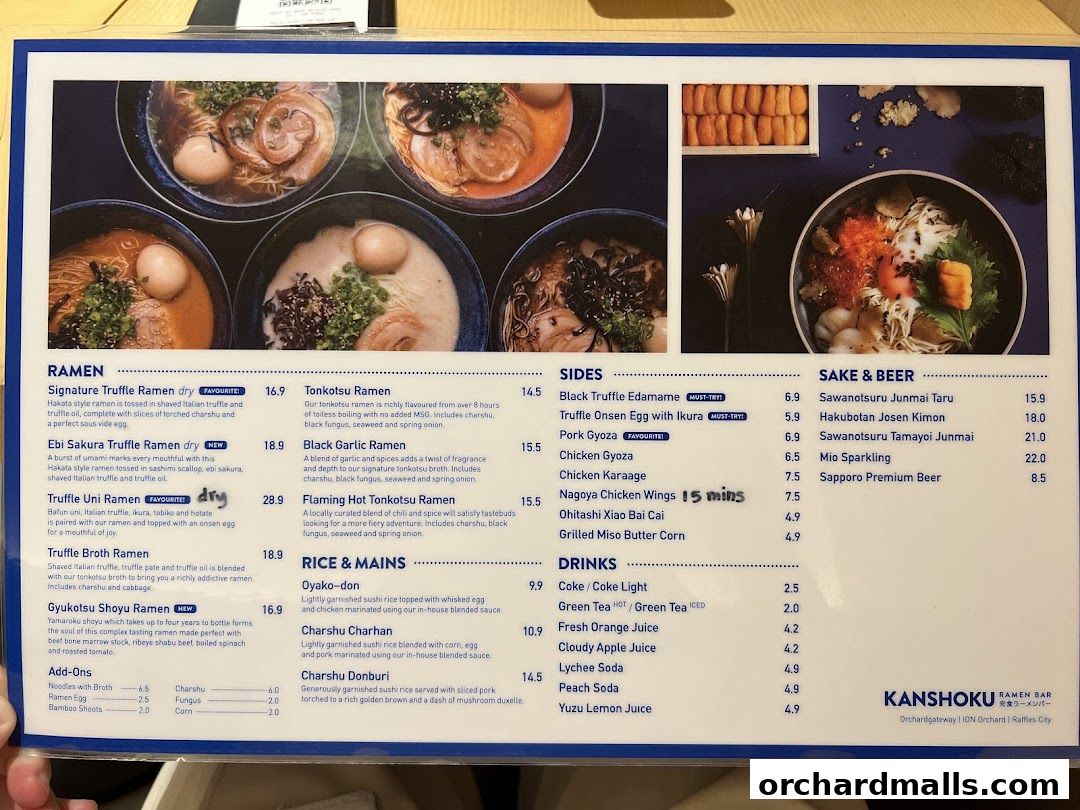 A menu from Kanshoku Ramen Bar featuring various ramen, sides, sake, beer, rice dishes, and drinks.