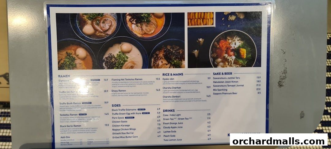 A menu from Kanshoku Ramen Bar featuring various ramen, rice dishes, sides, drinks, and sake.
