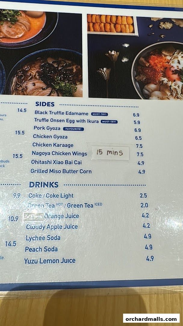 A menu from Kanshoku Ramen Bar featuring sides like gyoza and drinks such as soda and juice.