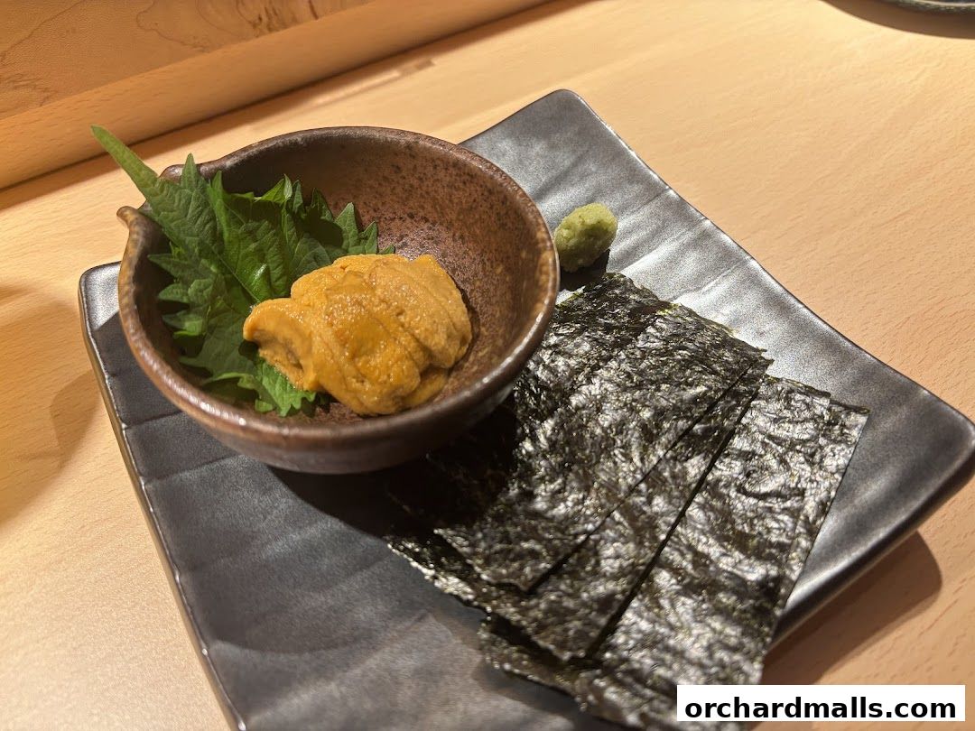 A serving of fresh uni (sea urchin) with nori sheets and wasabi.