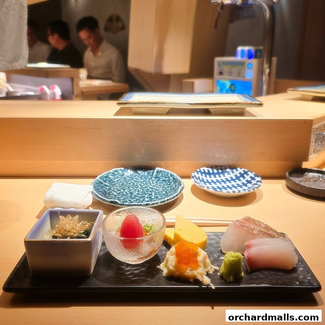 A beautifully presented sushi appetizer with various small dishes and fresh fish.