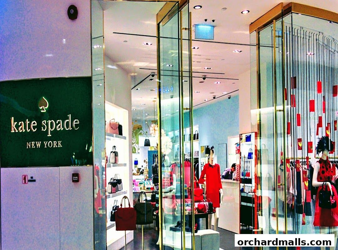 Interior view of a Kate Spade New York store showcasing handbags and apparel.