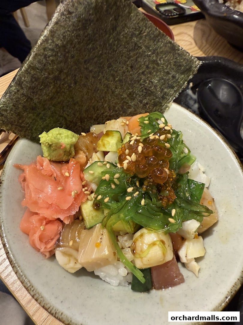 A bowl of Kaisendon with fresh seafood, seaweed, ginger, and wasabi.