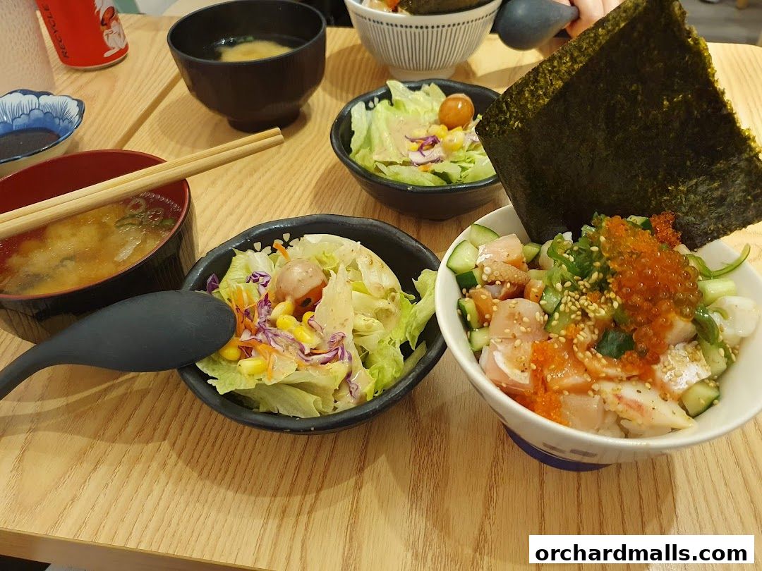 A close-up of a Japanese meal featuring Kaisendon, miso soup, and salad.