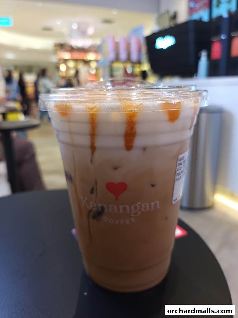 A close-up of an iced coffee with caramel drizzle from Kenangan Coffee.