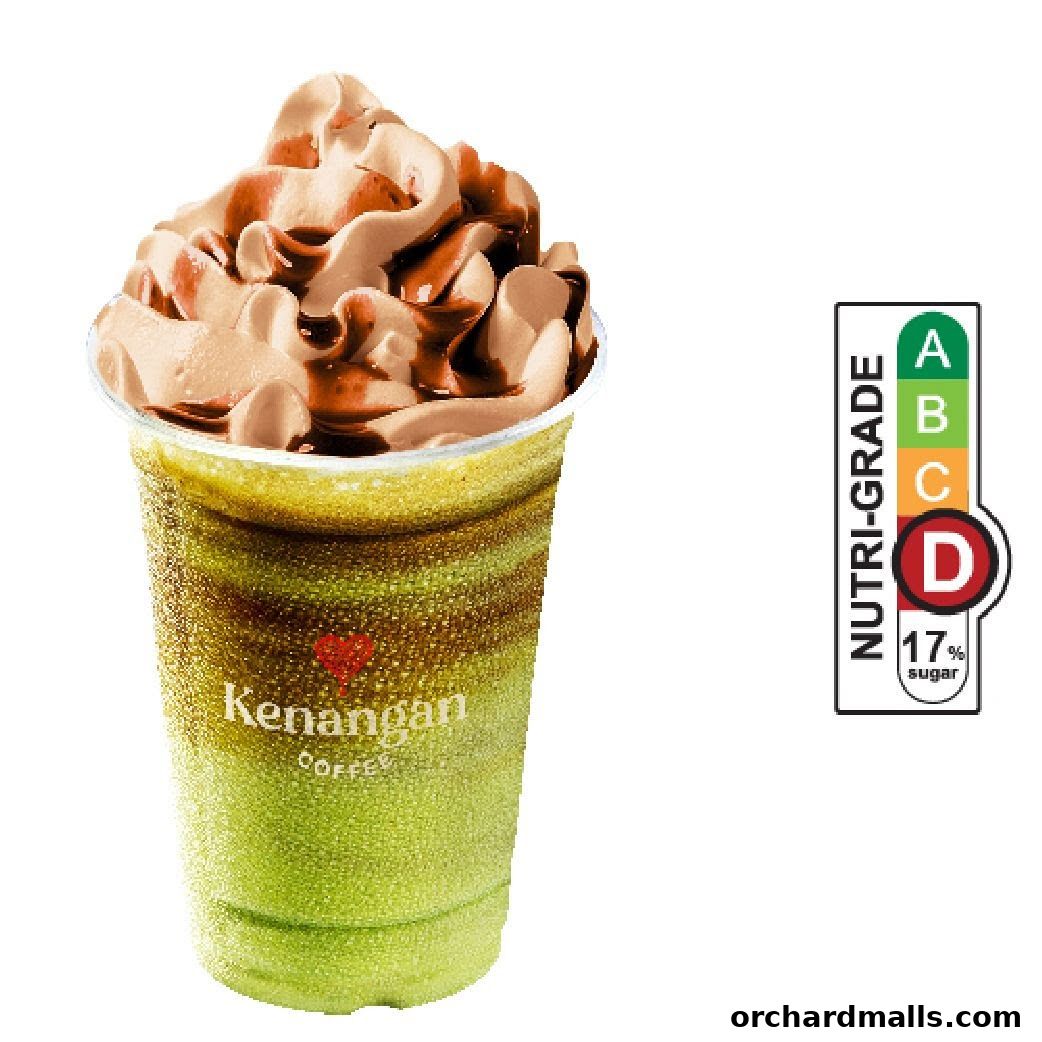 A layered green and brown iced coffee drink with whipped cream and chocolate drizzle.
