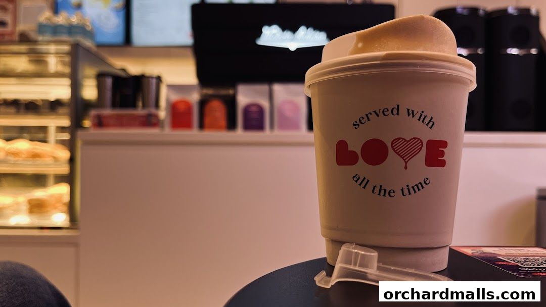 A coffee cup with 'served with LOVE all the time' text sits on a table.