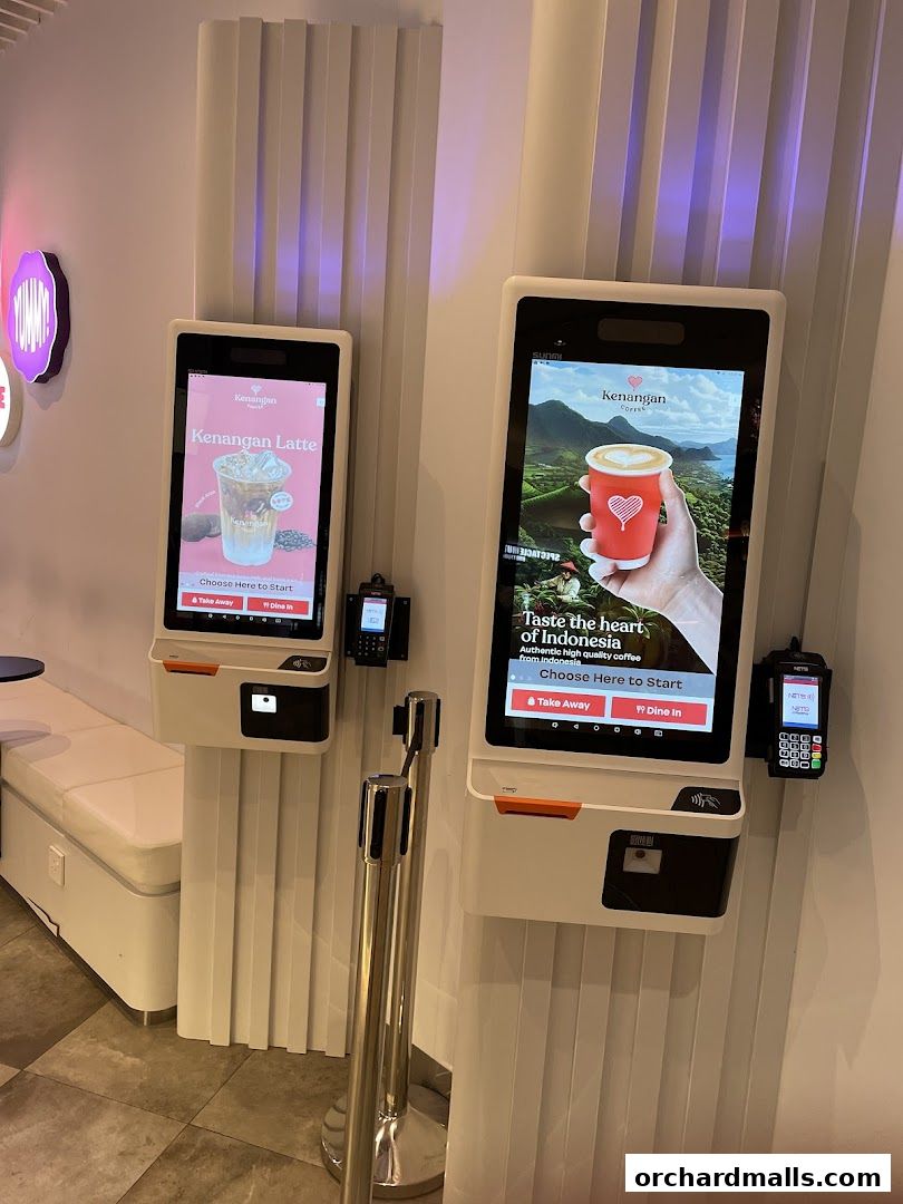 Two self-order kiosks for Kenangan Coffee at Takashimaya Shopping Centre.