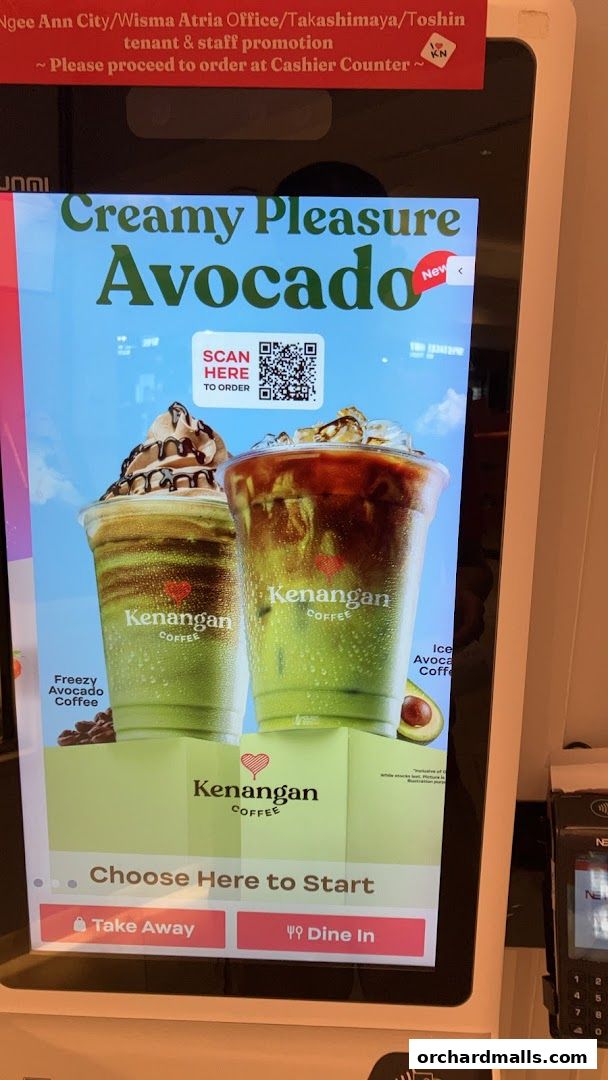 A digital menu screen at Kenangan Coffee showcasing their Creamy Pleasure Avocado drink.