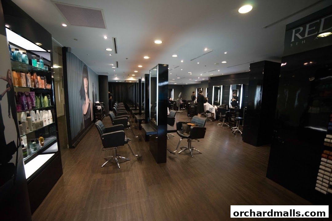 Interior view of a modern hair salon with multiple styling stations and product displays.