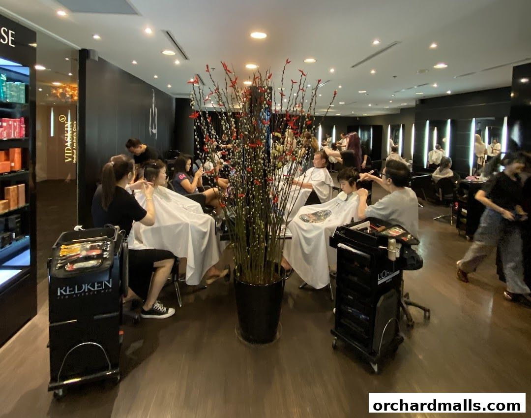 Interior view of a busy hair salon with clients receiving haircuts and styling.